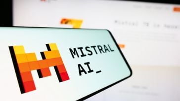 A photograph of a smartphone with the Mistral AI logo on it.