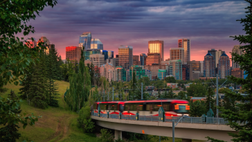 Sunset skyline view of Calgary. A tram is in the foreground.