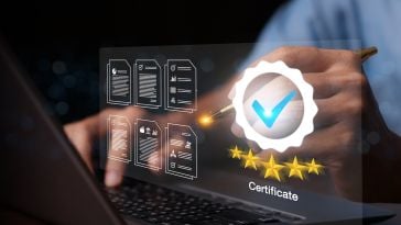 Photograph of a person at a laptop, with a graphic of certification and a checkmark on overlayed top