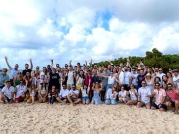 Large group of employees on a beach