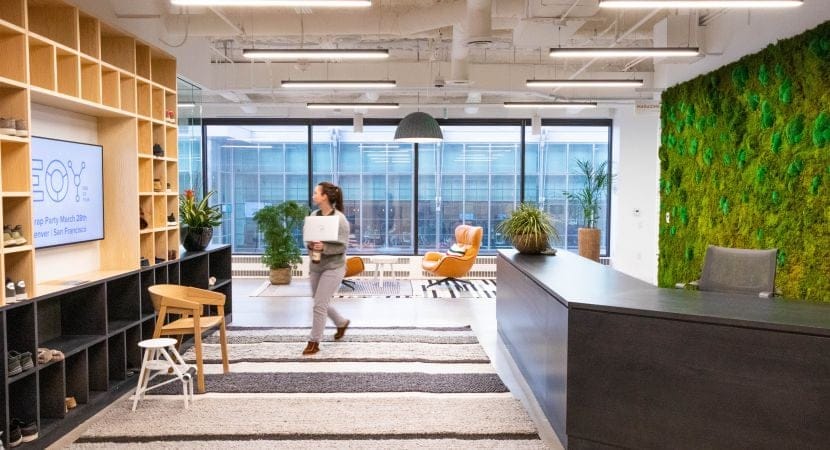 A woman walks in the Denver office