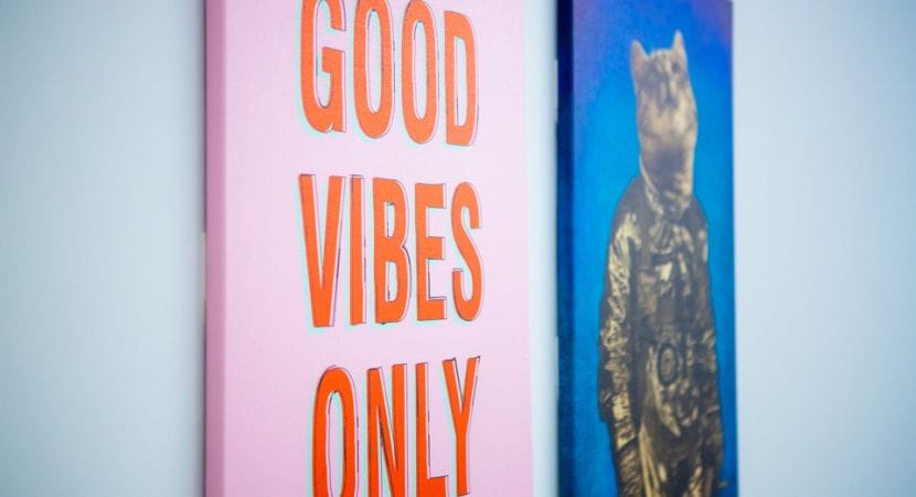 Photo of two wall canvas pictures, closest one says "Good Vibes Only"
