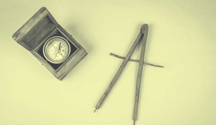 A yellow-toned image of a magnetic compass and a cartographical compass. meditation-studio-app-pivot 