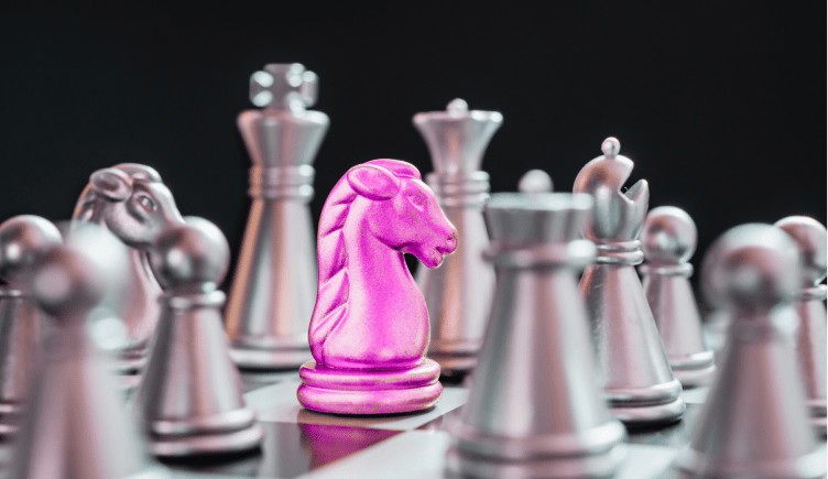 Chess pieces, with a pink knight. b2b saas positioning