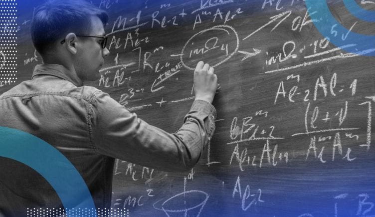 A physicist works on a problem on a chalkboard filled with equations