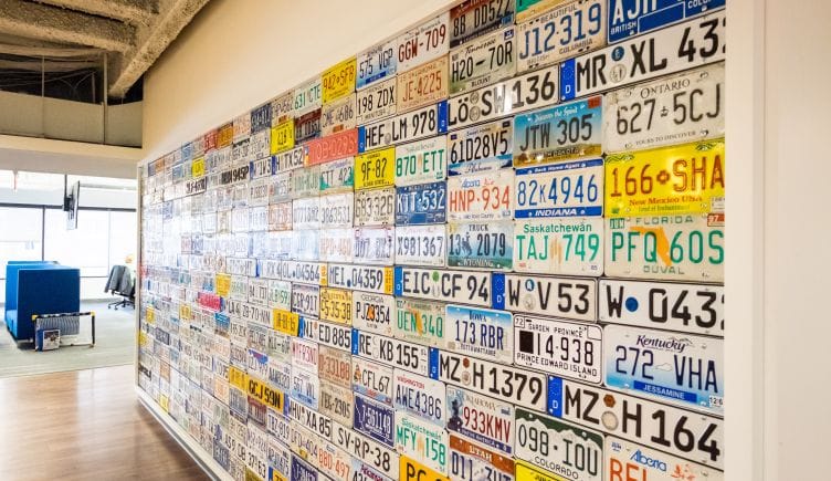 License plate wall in CarGurus' Boston office