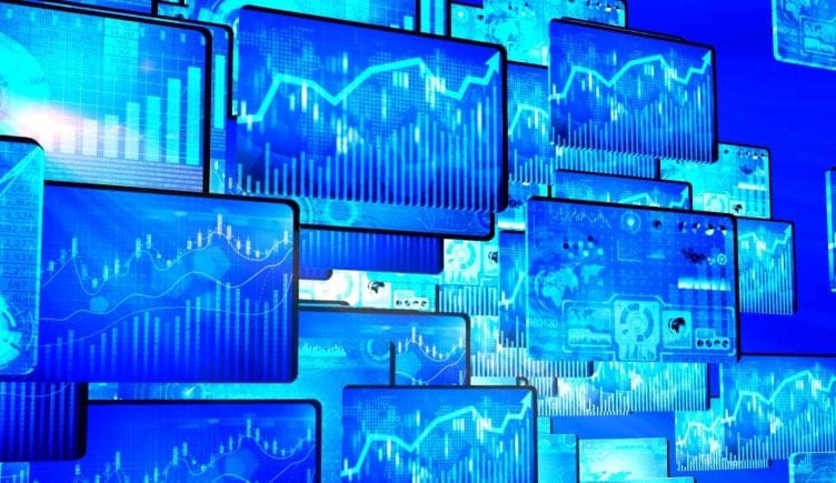 A collage of monitors displaying different data visualization formats. 
