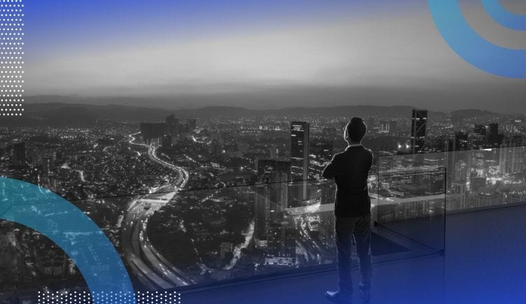 A person looks out on the city from a high vantage point