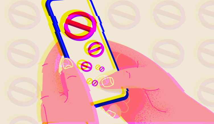 A person holding a mobile device with an anti engagement symbol blocking them from using it.