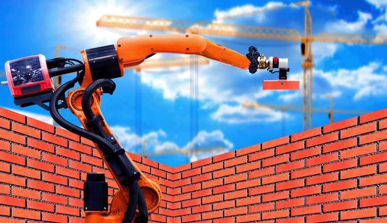 A construction robot laying bricks to build a wall.