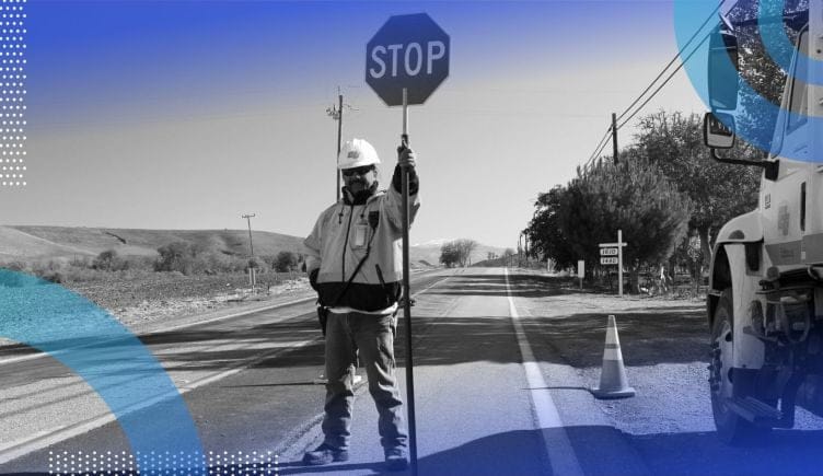 Construction worker holding stop sign in traffic representing rate limiter concept