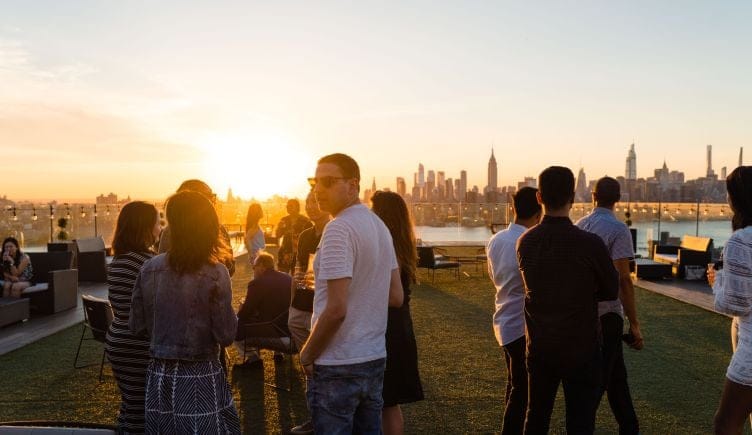 Cadre employees enjoy sunset over the NY skyline. 