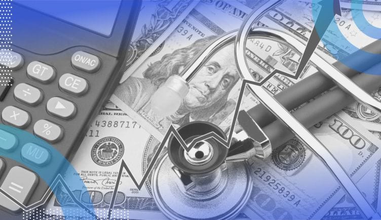 A stethoscope sits atop a pile of money with a calculator and a rising trend line