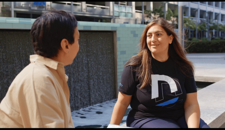 Two DIRECTV employees meet in a beautiful outdoor space