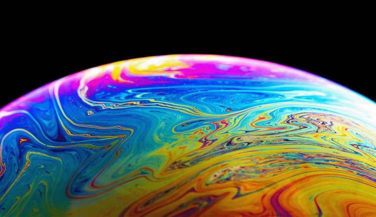 A close-up view of a bubble reflecting a rainbow of colors.