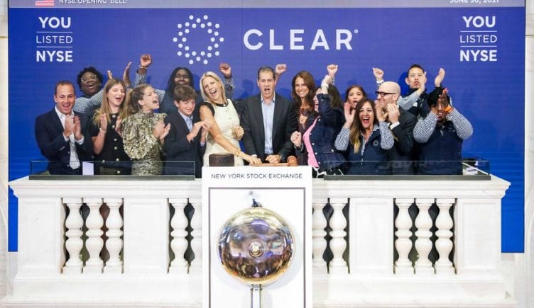 Members of the CLEAR team ring the bell at the New York Stock Exchange