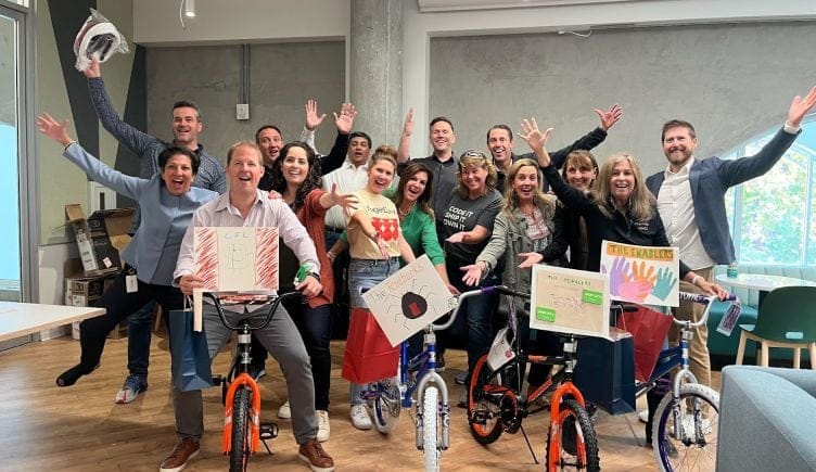 PagerDuty employees on bicycles in their office