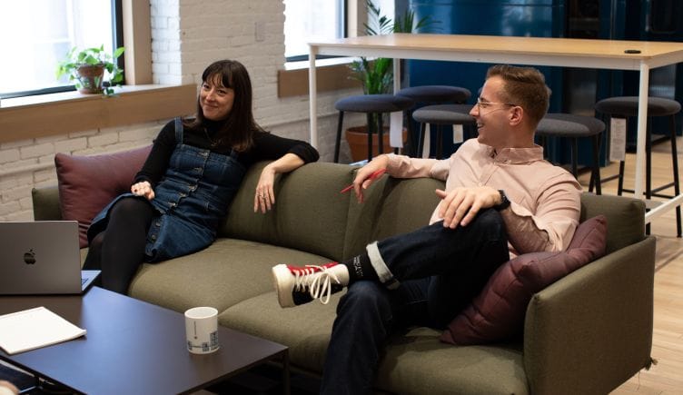 Contensquare team members lounging on couch in office
