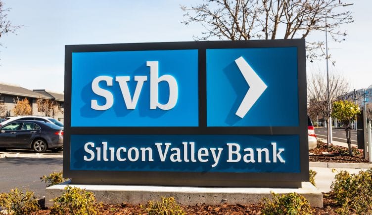 A sign for Silicon Valley Bank in a parking lot.