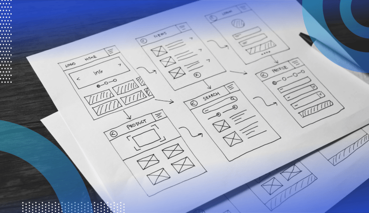 Wireframes image of a piece of paper with a desk with six wireframes drawn on it