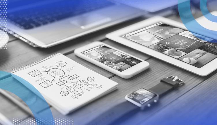 responsive web design image of a desk holding a smart watch, a smart phone, a tablet and a laptop with a sketchpad 