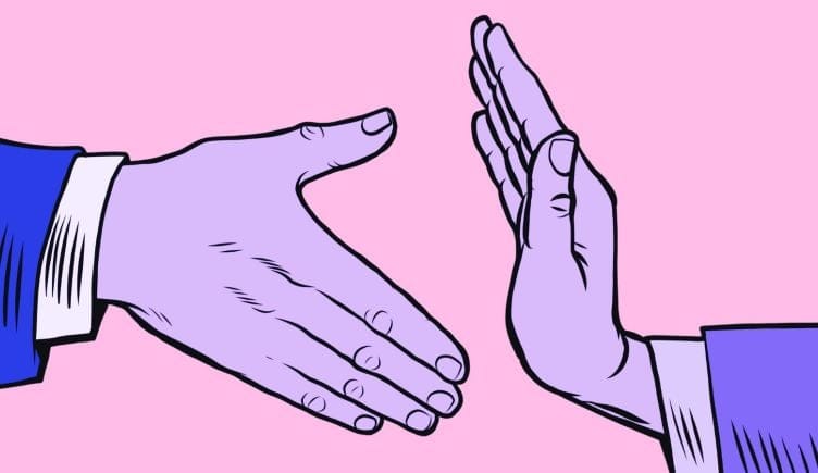 Two illustrated hands are pictured against a pink backdrop. One of the hands is extended for a handshake, but the handshake is blocked by the other hand — similar to the way an employer can block a new hire by rescinding a job offer.