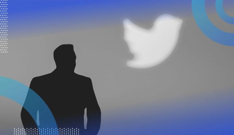 A silhouette of Elon Musk in front of the Twitter logo