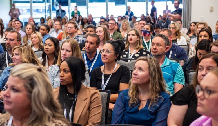 Photo of audience of DISH employees at a large presentation