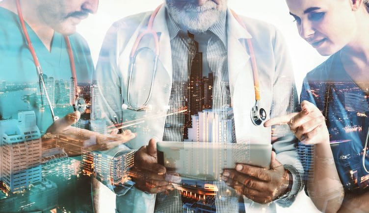 An artistic rendering of healthcare professionals poring over a tablet. An image of a cityscape is faintly overlaid. 