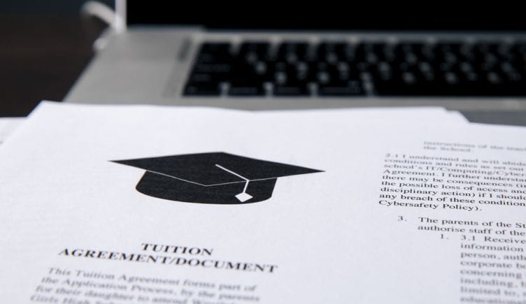 A close up of tuition paperwork with a graduation cap illustration at the top of the page.