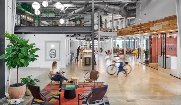 Photo of the interior of Favor's Eastside tech hub office space, with people moving about.