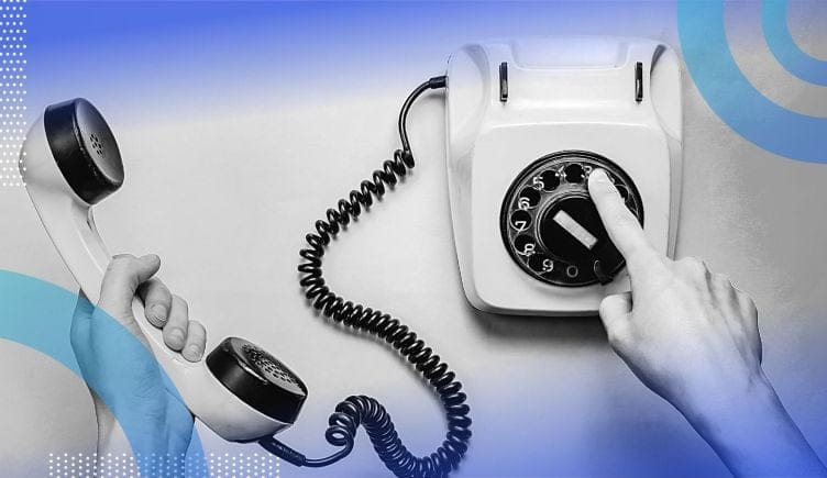 Person dialing a number on a rotary phone