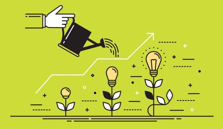 A hand watering several light bulbs at various growth phases, signifying ideas and startup growth