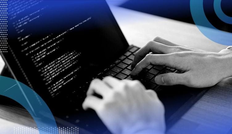 Developer writing python code on a laptop