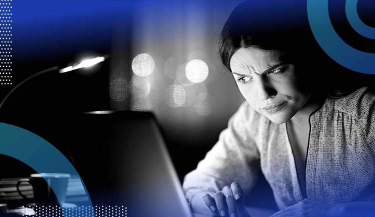 A person looking at a computer with suspicion.