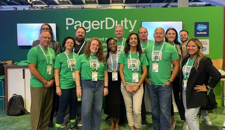 PagerDuty team members in green shirts in front of PagerDuty booth at a conference