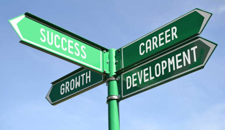 a signpost points toward “success,” “growth” and “career development”