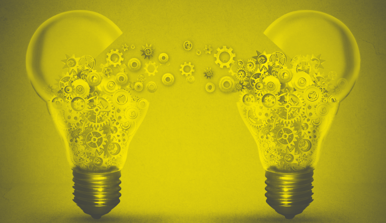 Two light bulbs swapping cogs to illustrate innovation collaboration concept.