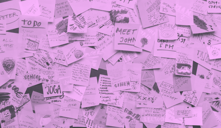 A wall covered with post-its with a variety of tasks on them.