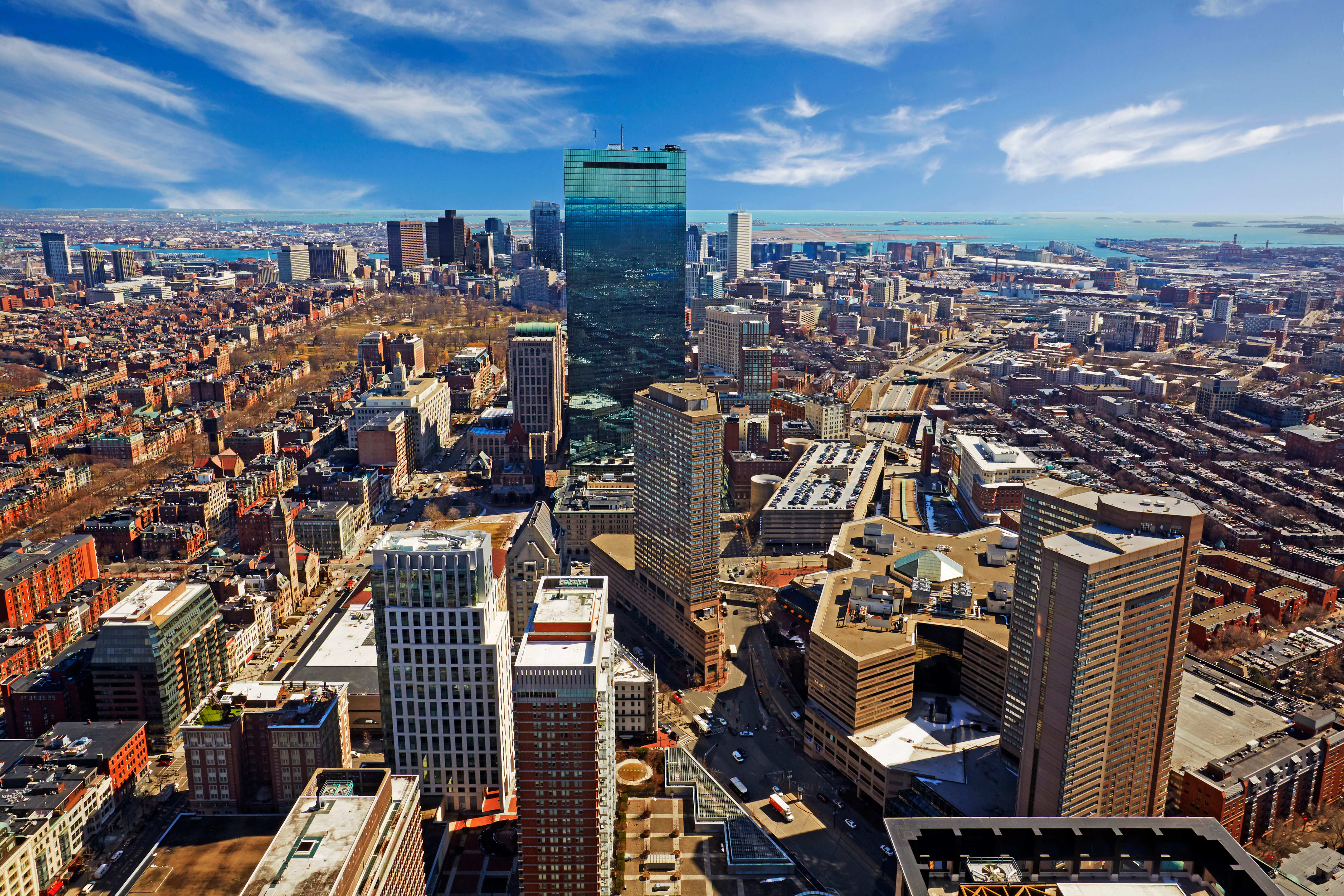 The Boston skyline with Faneuil Hall and Quincy Market in the foreground.