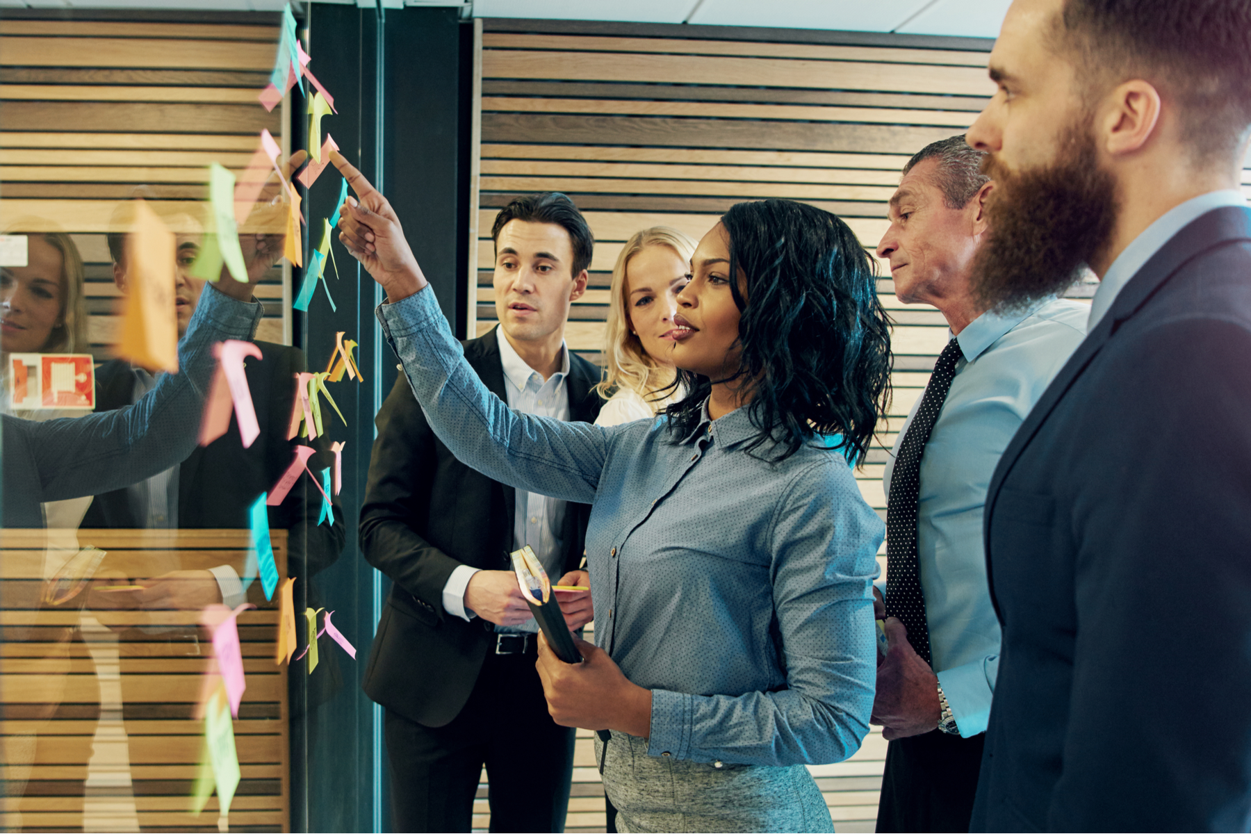 A group of employees work on company goals together.