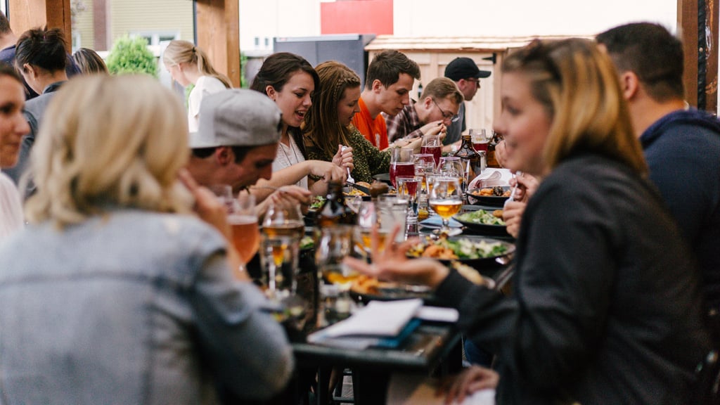 A group of coworkers enjoying a meal at a restaurant together.