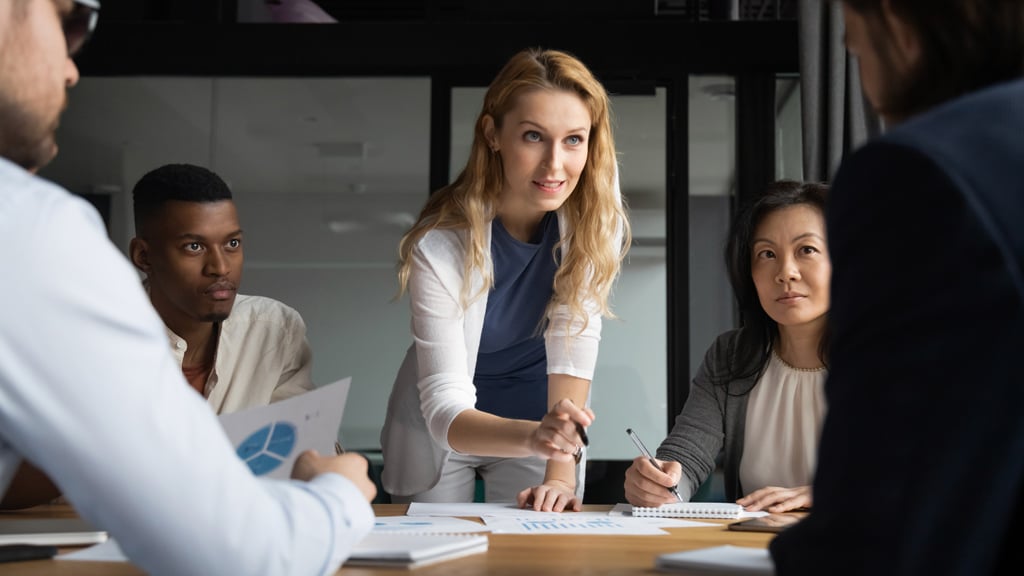 A business woman leading a meeting with colleagues