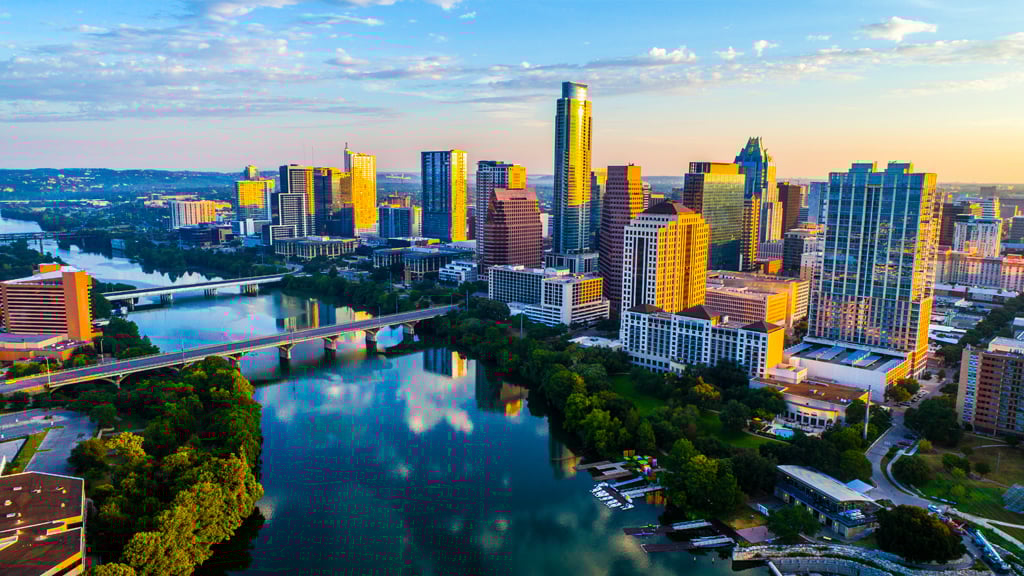 Austin, Texas skyline at sunrise with reflection in Town Lake
