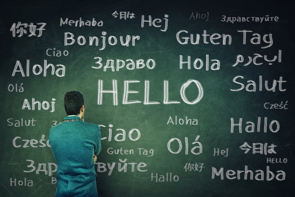 Man looking at different words that mean hello in many languages.