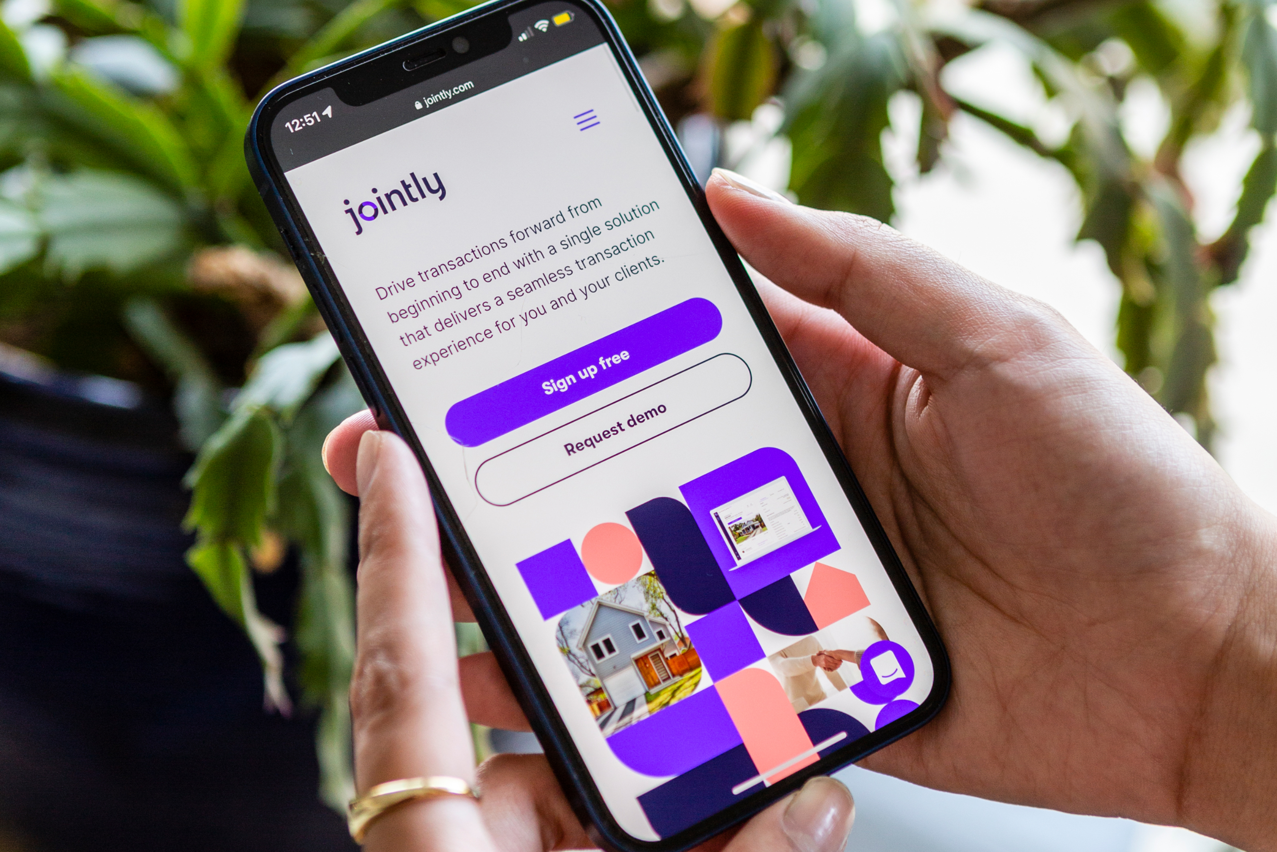 Jointly app on a phone in someone's hands.