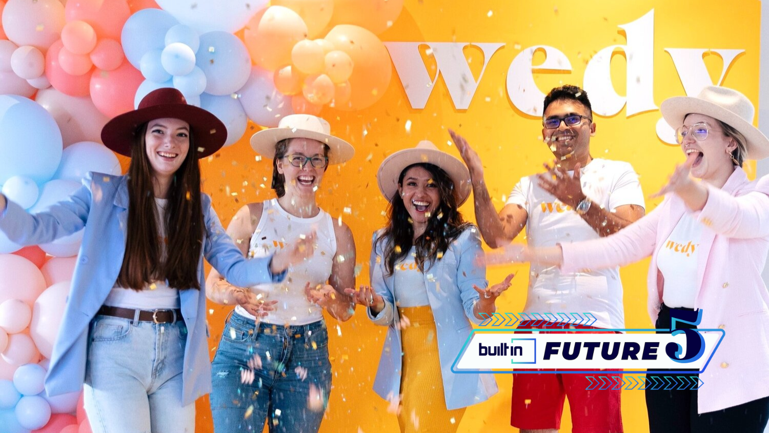 Wedy staff toss confetti in the air