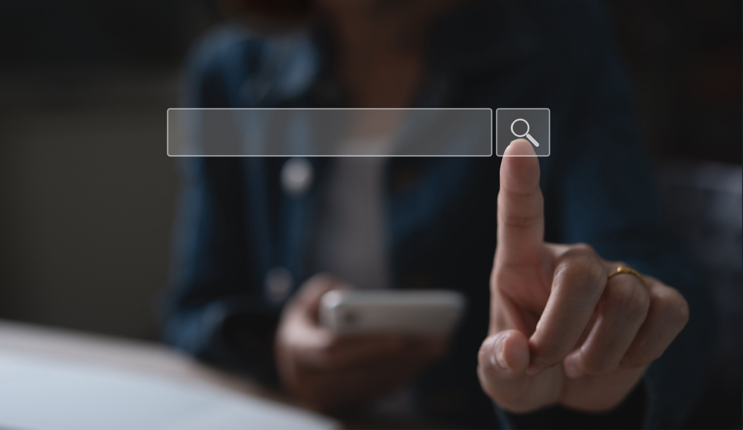 photo of person pointing a finger at a search bar