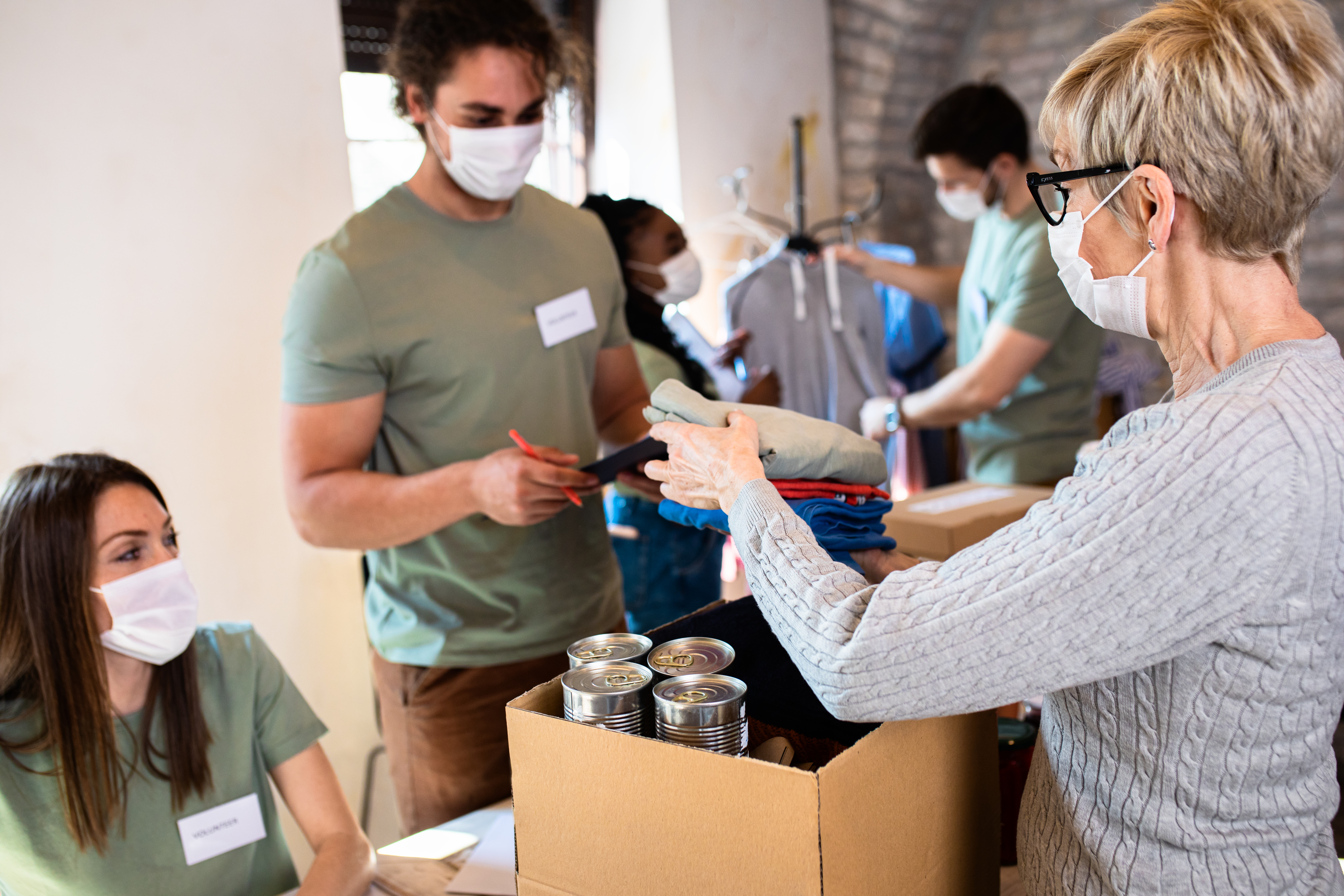 Group of people handing doing volunteer work.