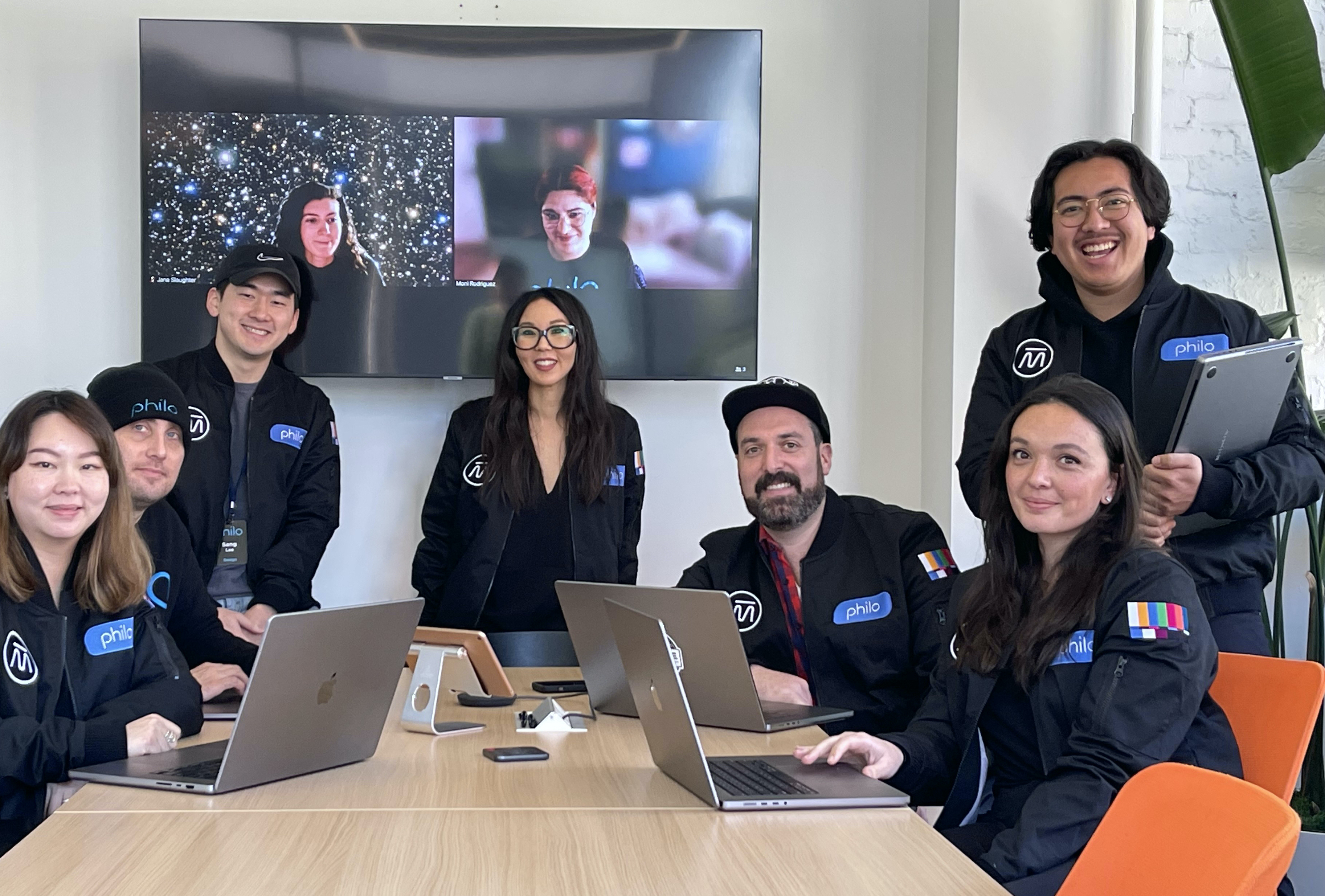 Left to Right: Damien Ivan, Aom Rattanasaksopana, Rafael Cuevas, Sandy Micone, Brandon Yap, Camille Hogan, Sang Lee, (On TV): Monica Rodriguez, Jane Slaughter.